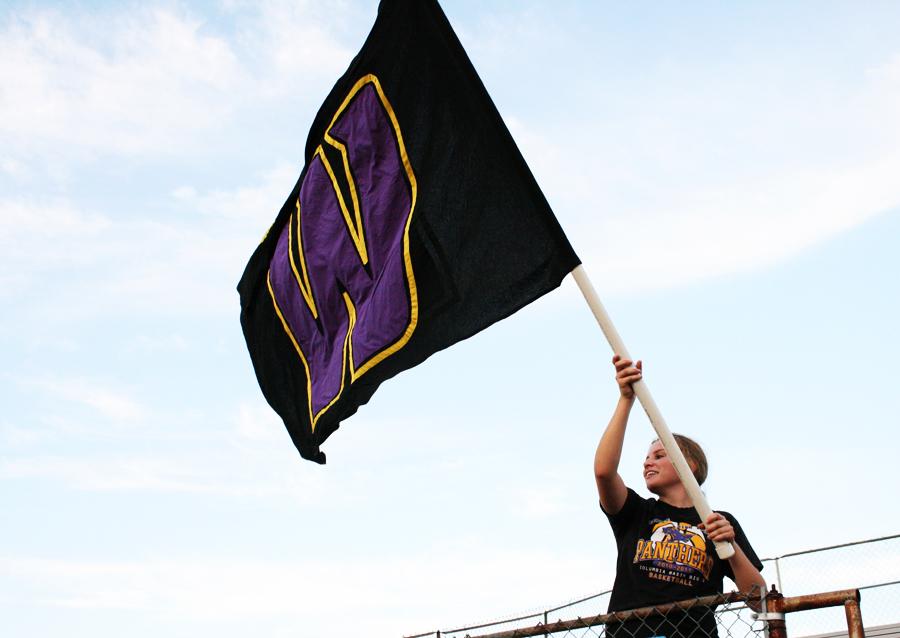 Abby+McKay%2C+12%2C+waves+spirit+flag+in+the+student+section.