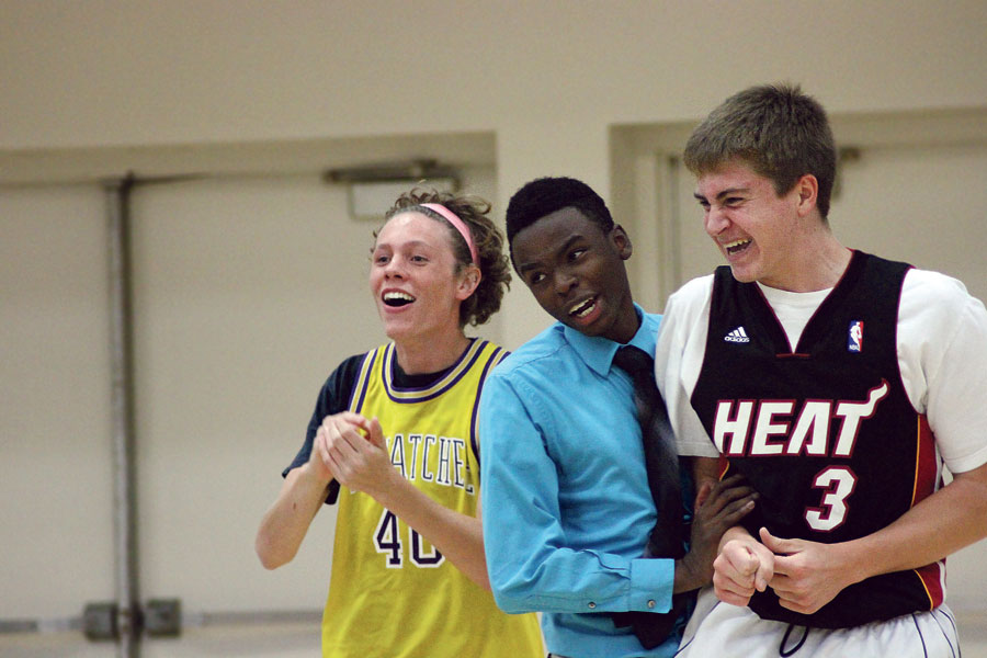 Players sophomore Jack Gavin (left) and sophomore Gavin Long (right) and coach Austin Conklin (middle) cheer for their team, Spike “n” Ikes, during Buff Puff on Sept. 30. Their team won first place in the tournament, putting a number of teams in the dust. 