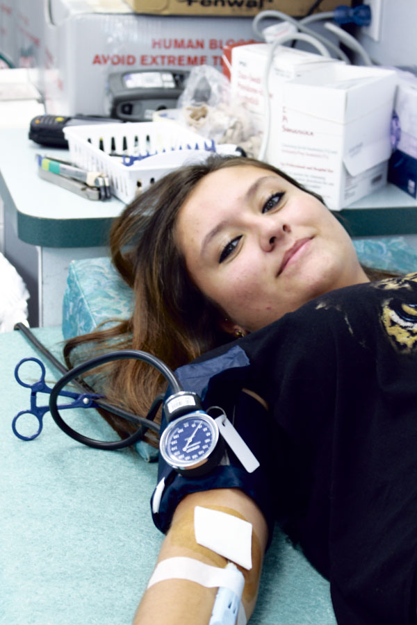 Junior Itzel Hurtado  gives back by geting her blood drive while her bood pressure is monitored during the blood drawn on Sept. 23 and 24.  Over 150 people signed up for the, donating 59 pints of blood and saving 172 lives. 