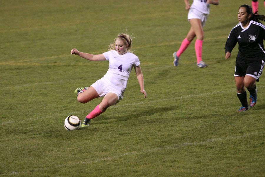 Senior forward Emily Rader passes the ball to a teammate.