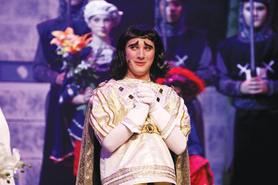 Junior Josey Meats, who played Lord Farquaad, ponders his upcoming marriage with Princess Fiona, played by juniors Maddy Atwood and Alex Stroming, during the second act of Shrek: The Musical.
