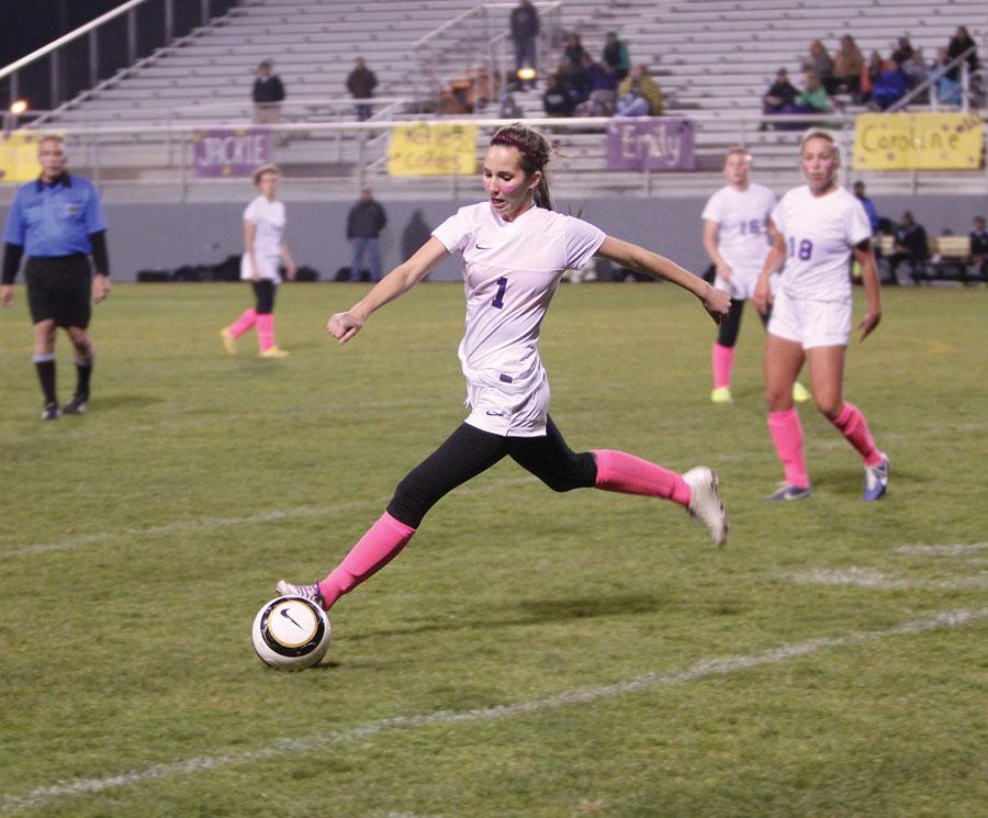 Sophomore Rachel Linderman passes the ball to her teammate at the Apple Bowl during the Panthers final league  game against Davis on Oct. 29. To support Breast Cancer Awareness Month, the Panthers all wore pink socks and pink face paint. The Panthers beat Davis, 2-1.