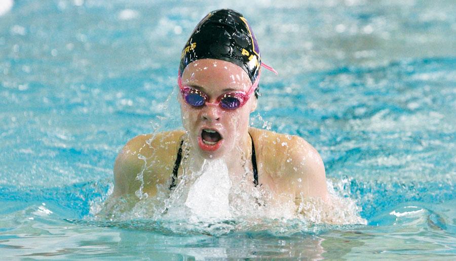 Sophomore Kayli Elwyn swims into the wall during the 200 individual medley at Eastmont High School on Sept. 24. At Districts on Nov. 1 and 2, Elwyn placed second in the 200 freestyle and the 500 freestyle, qualifying her for State in both.