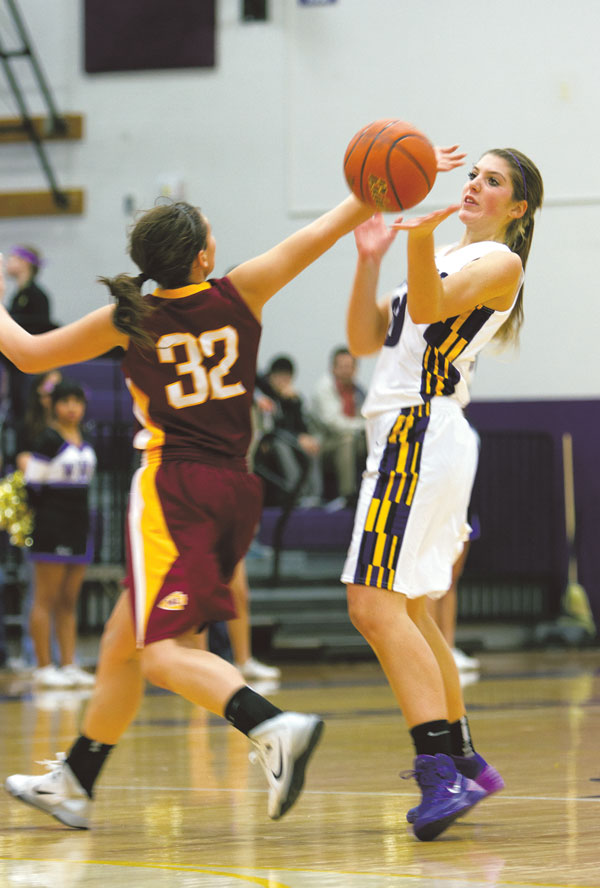 Junior Ali Sealby fights her Moses Lake opponent for possession of the ball on Dec. 13 at home.
