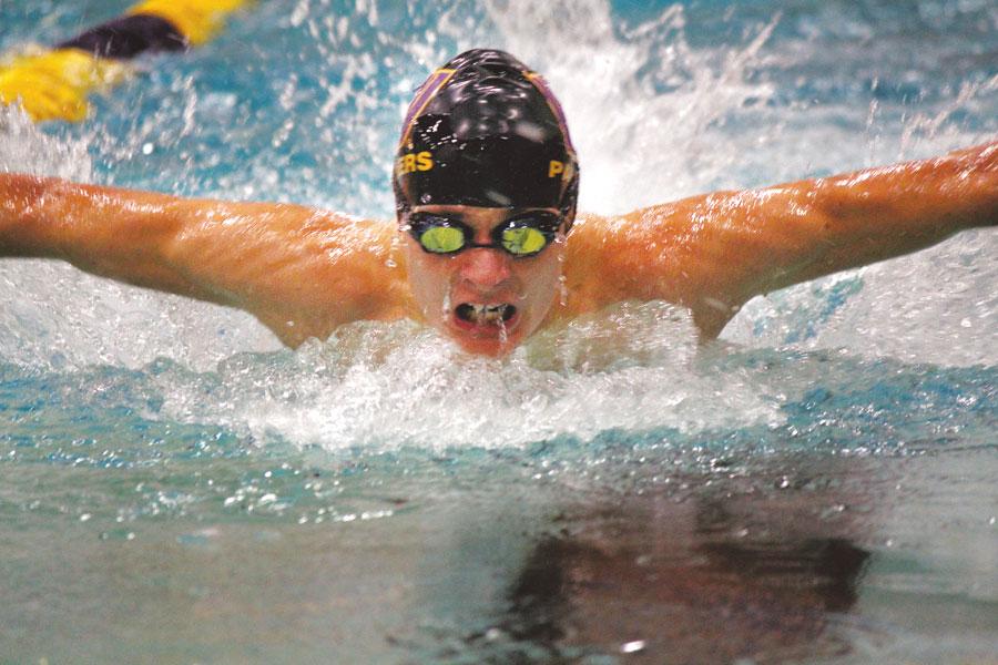 Junior Justin Pringle powers into the wall during the 200-yard individual medley on Dec. 12 at home against Moses Lake. Pringle finished with a time of 2:29.77. Although the Panthers lost 105-80, they showed a strong performance, taking first place in several events.