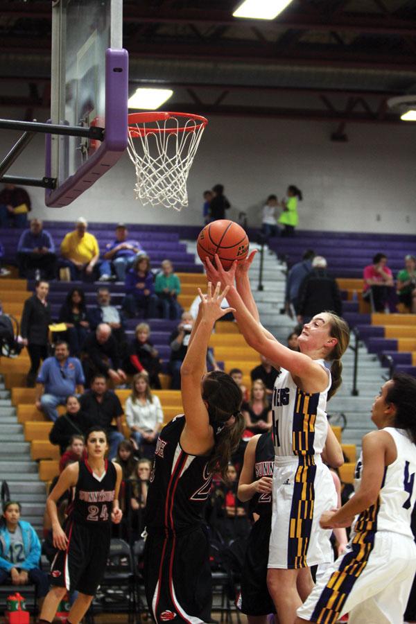 Sophomore Maddi Hallberg reaches for a basket against Sunnyside on Jan. 17. 