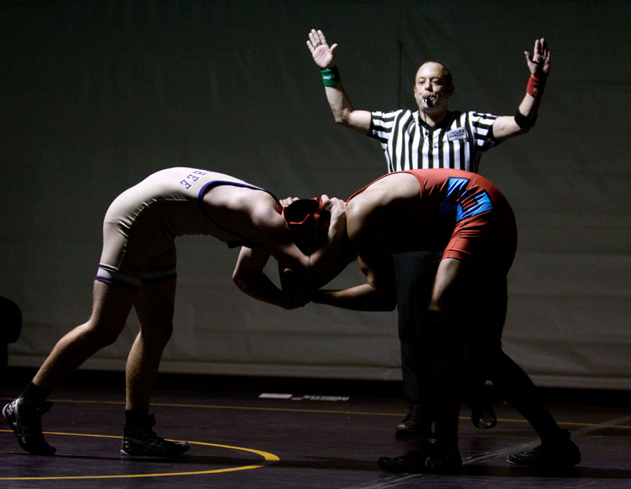 A match begins between a Wenatchee wrestler and an Eastmont wrestler.