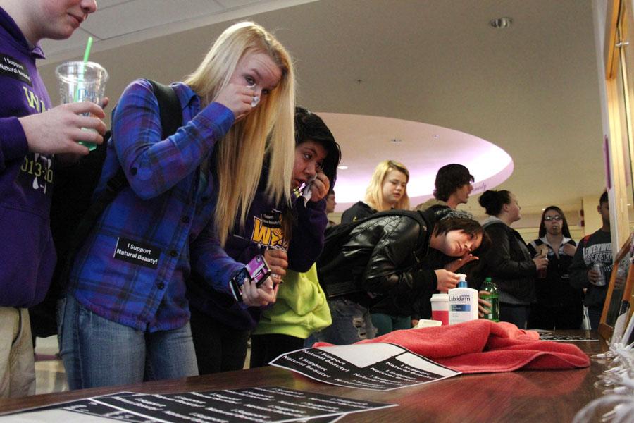 Students take off their makeup inside the front doors of WHS on Feb. 28. 
