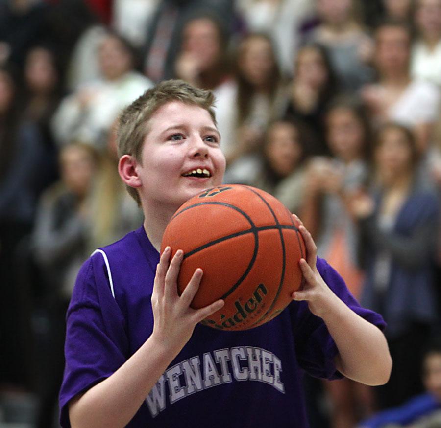 Freshman Dylan Hermanson attempts a shot during a spirit assembly on Feb. 7.