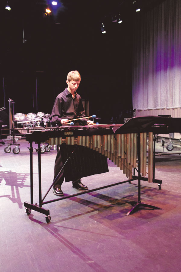 Freshman Spencer Engel plays his piece on the marimba in front of a judge at the Solo and Ensemble contest.