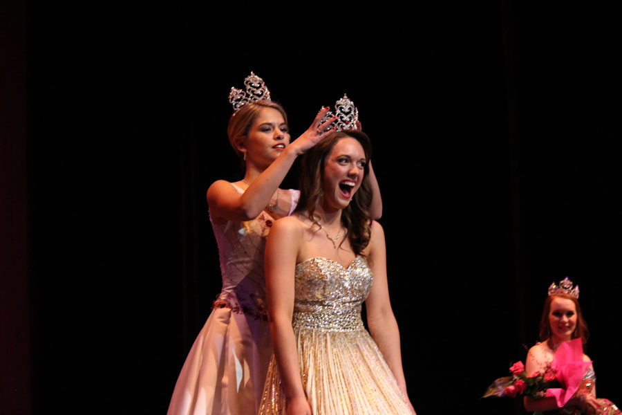 Senior Roslyn Thompson is crowned by former Queen Emily Abbott in front of a packed Wenatchee High School auditorium. 