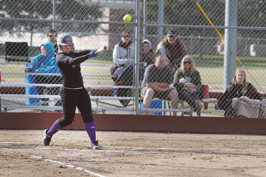 Junior Carley Gangle powers a ball out to left field at the Panther’s first game of the season on March 19. The Panthers won 15-5. Gangle is a catcher for the varsity team.