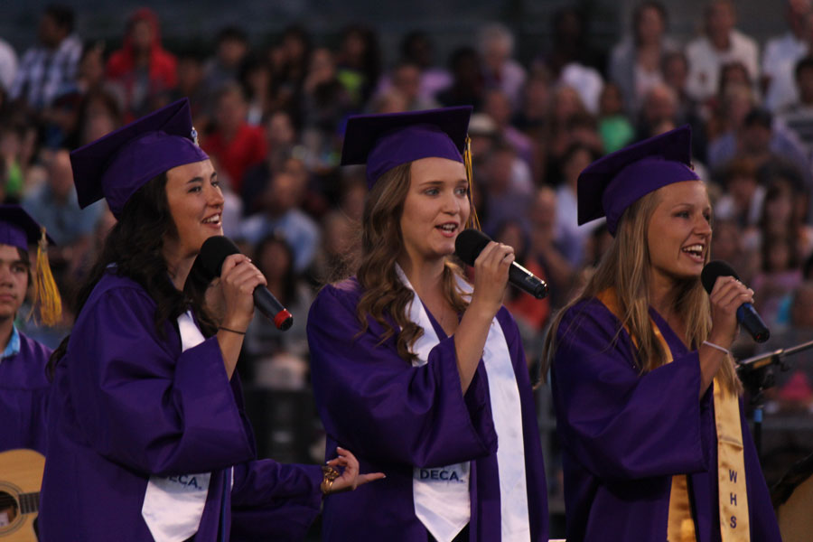 Seniors Catherine Ross, Carie Graves, and Alisa Monda provide musical entertainment to the Class of 2014, singing Be Ok.