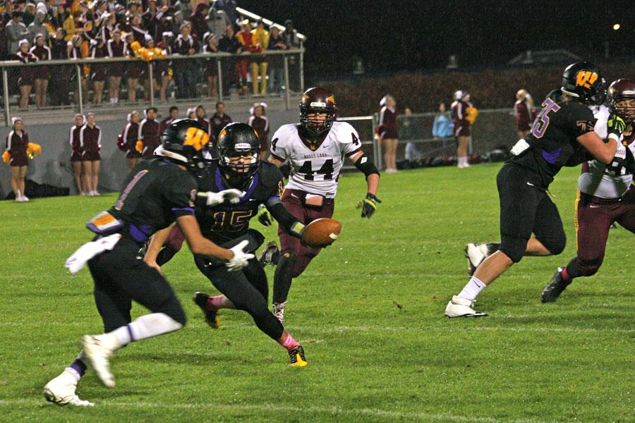Senior Chase Resch and junior Brandon Graves pull off a play against Moses Lake during Fridays rainy Homecoming football game.