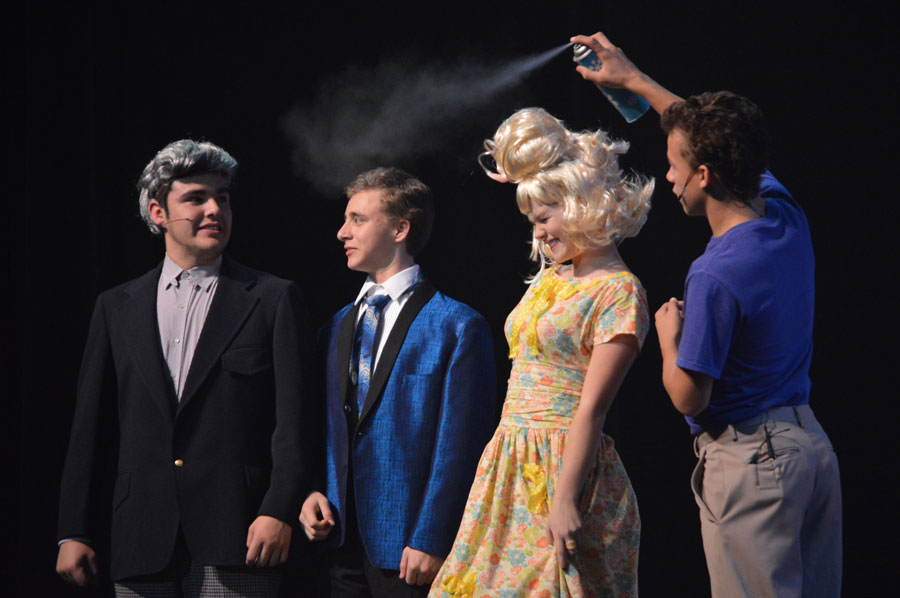 Junior Bella Dahl, known as Amber VonTussle in Hairspray, is doused with hairspray by her partner on the show, freshman Luke Ferrell, who plays Link Larkin. 