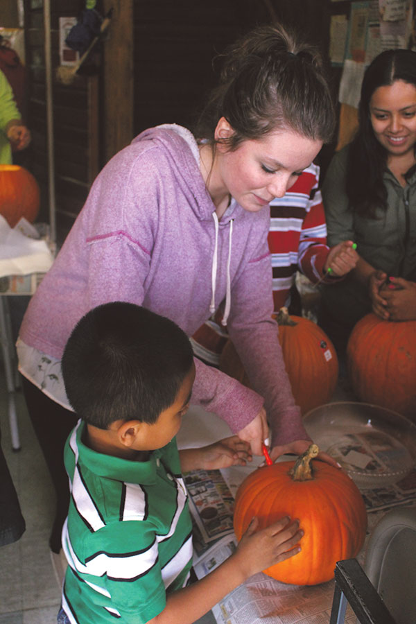 Sophomore Delaney Yant helped one of the many children. This was her first time volunteering at the pumpkin carving event.