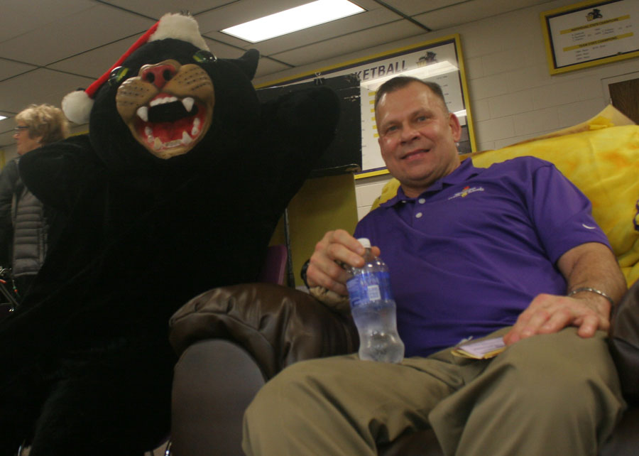 Sitting at the “Best Seat in the House,” the Panther mascot and Wenatchee schools Superintendent Brian Flones relax during halftime of the varsity girls basketball game on Friday. The recliner, donated by Sav-Mart, is helping the Golden Apple Band raise travel money one raffle ticket at a time.