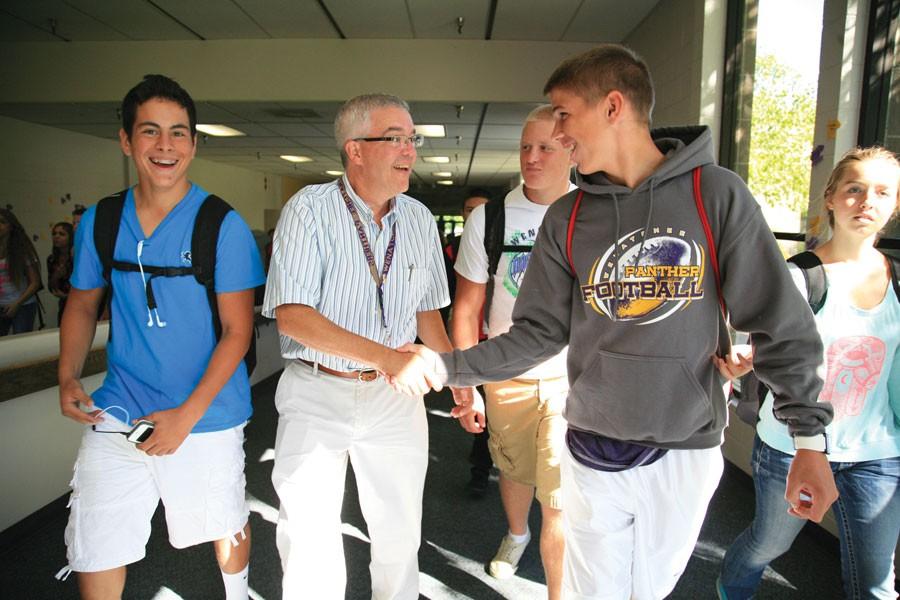 Principal+Bob+Celebrezze+shakes+hands+with+a+student+during+his+first+month+as+principal+at+Wenatchee+High+School+in+2013.