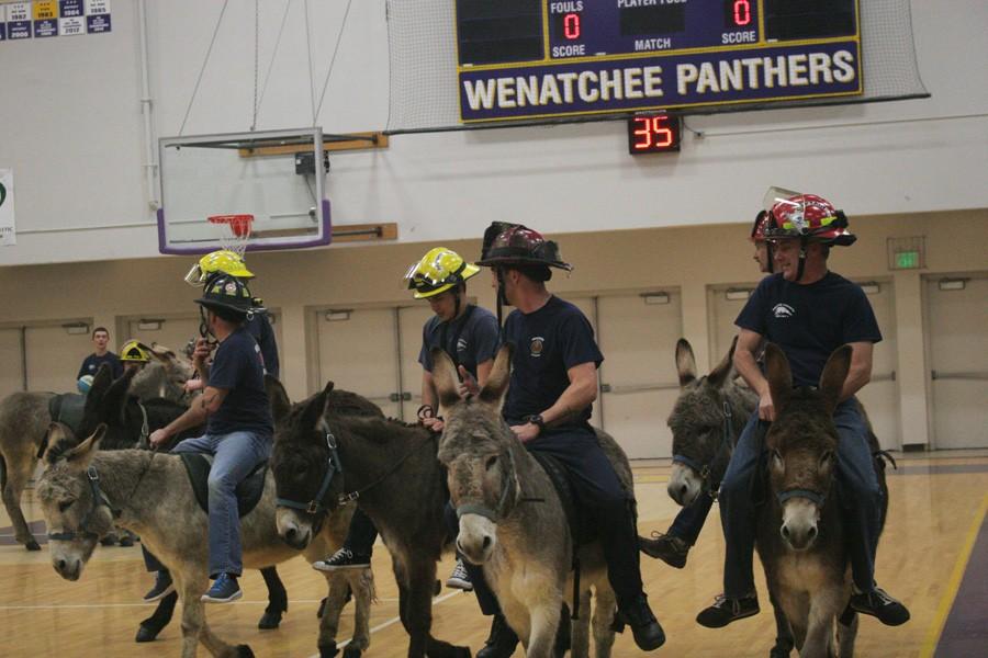 Members of the Wenatchee Fire and Rescue team compete in Donkey Basketball on Monday night. The won the championship round, 14-8.