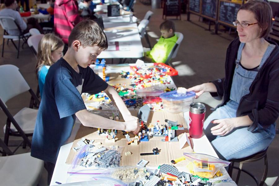 A boy builds Legos with his mother at Pybus Public Market on Saturday. The event was put on by Wenatchee High School students.