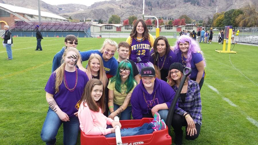 Wenatchee High School students gather around Makenna Schwab at the Homecoming Assembly, after donating more than $600 to her Make A Difference Day project.