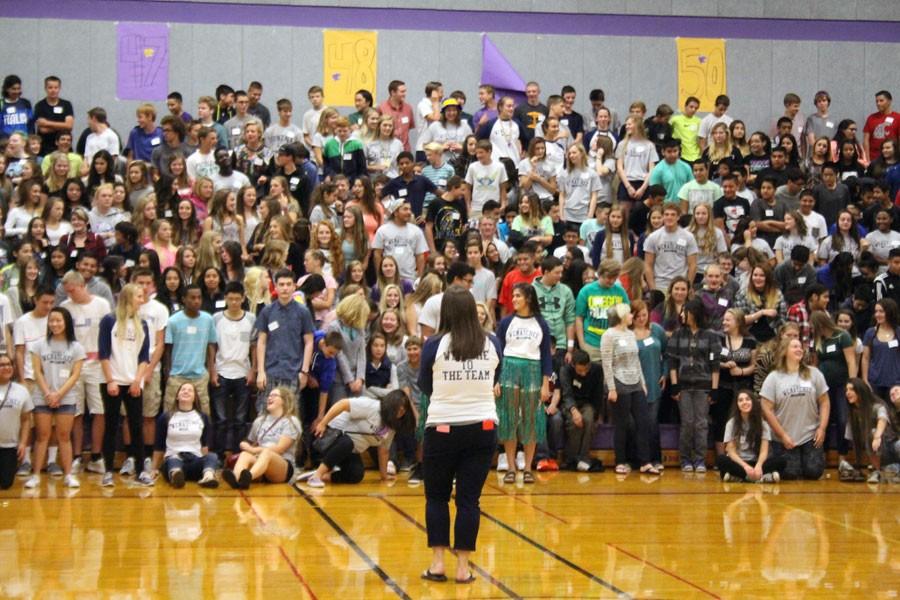Freshman IGNITE advisor Molly Butler leads freshmen in a game of Simon Says after welcoming them to the school