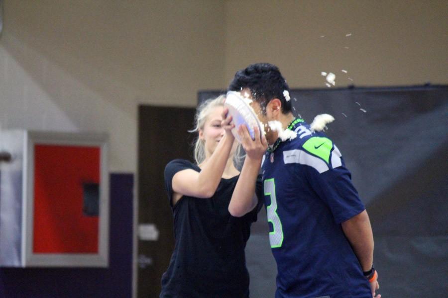 Sophomore Tara McBride slams a pie into the face of math teacher Rudy Joya.