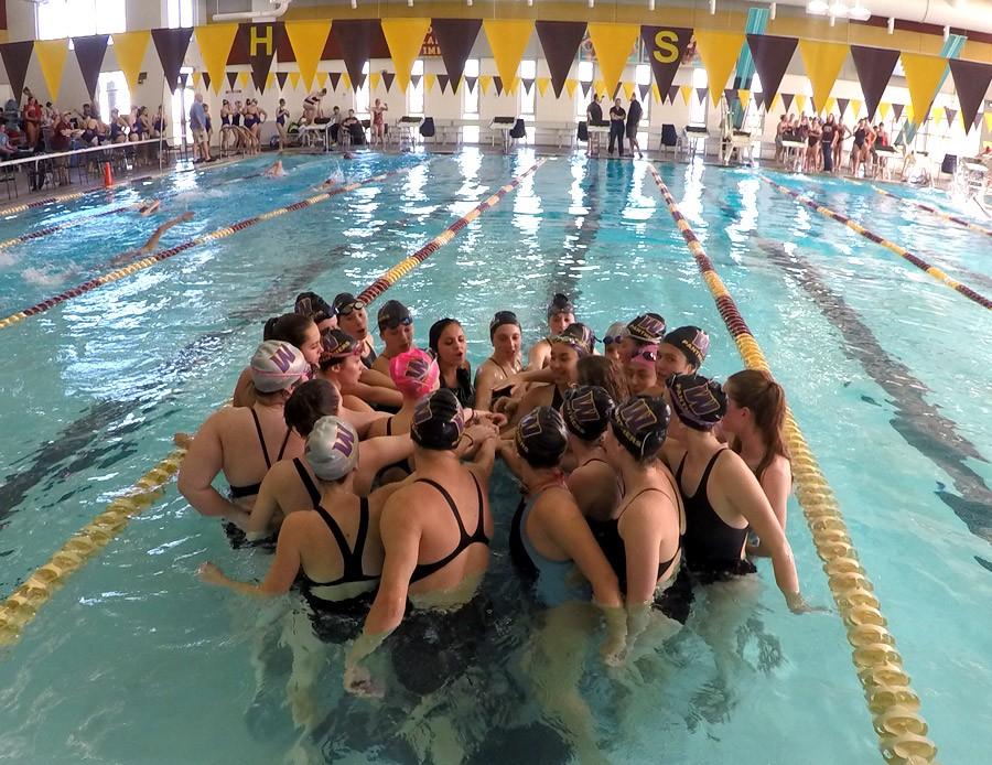 The Panther swim team huddles together before the meet