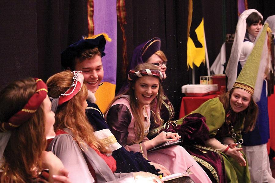 Anna Felming, center, laughs and revels with her fellow troubadours  throughout the feast.
