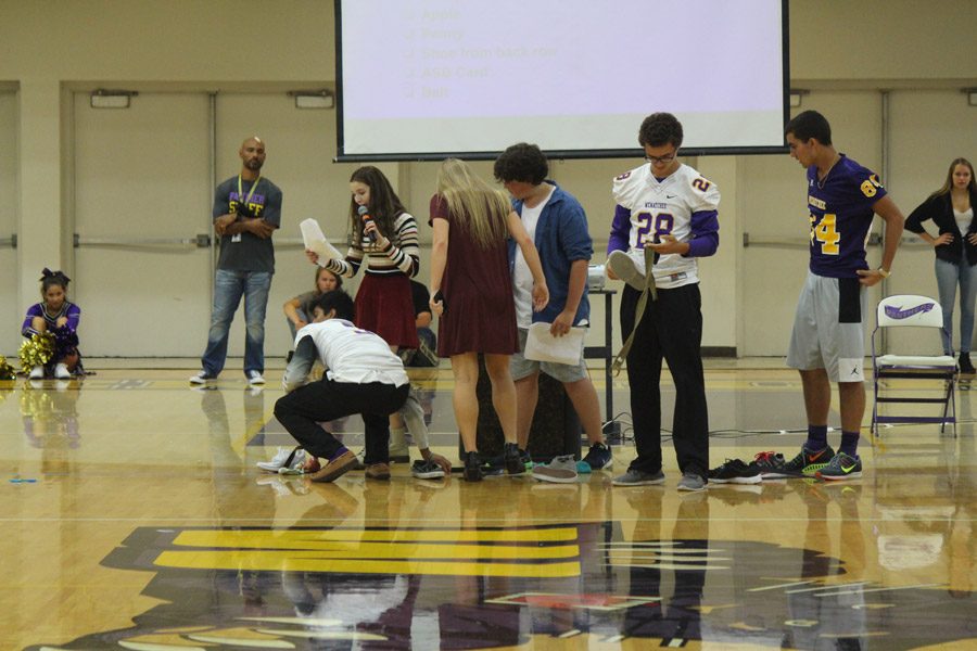 Students compete to gather miscellaneous items from the crowd. 