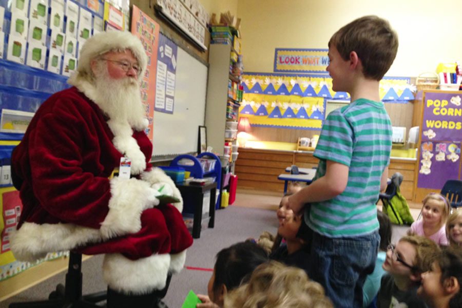 Bill+Higgins%2C+dressed+as+Santa%2C+delivers+letters+to+elementary+school+students.+%28Photo+provided+by+Molly+Butler%29