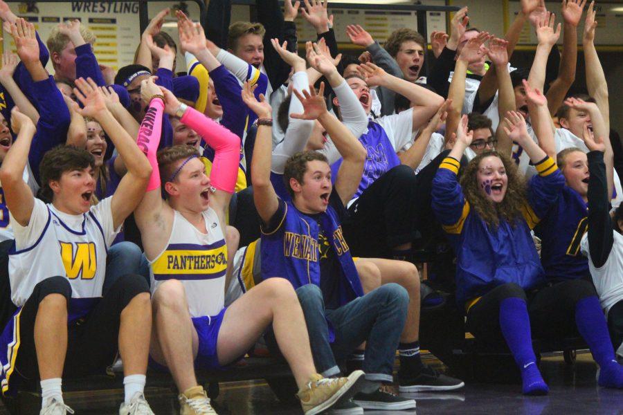 The student section practices their roller coaster cheer routine.