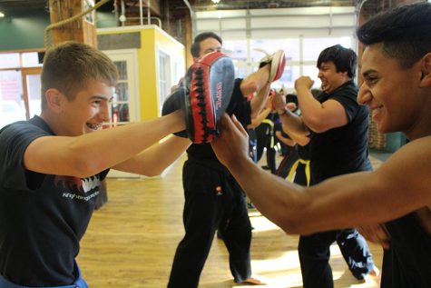 Hernandez coaches student Marcus Lolos through straight punches at Ki Fighting. 
