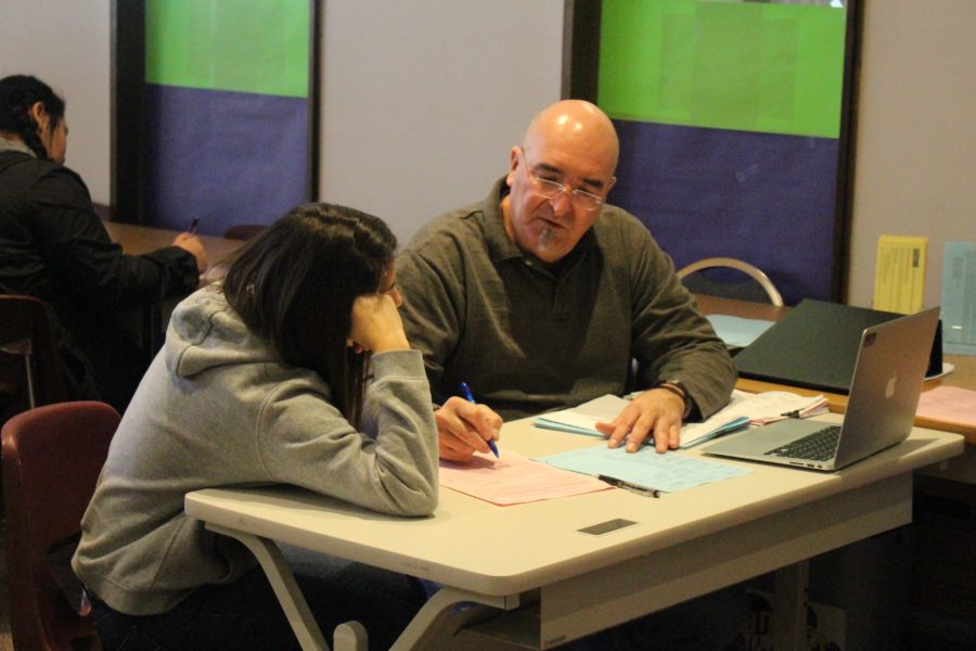 Counselor Doug Taylor works with a student on a class schedule for next year. 