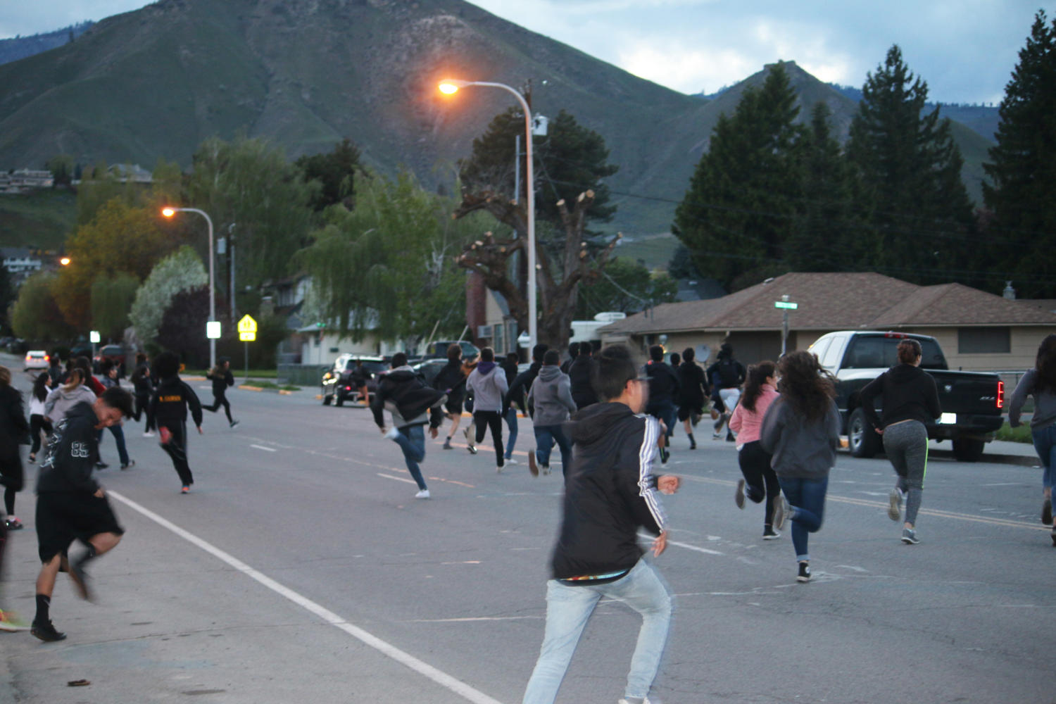 Students run across the street from the High School. 