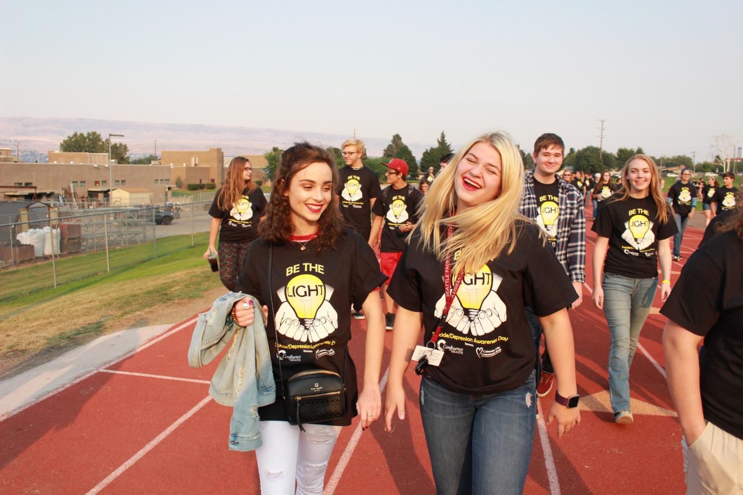 Juniors Hannah Moore and Karissa Long walk to support the Be the Light movement.