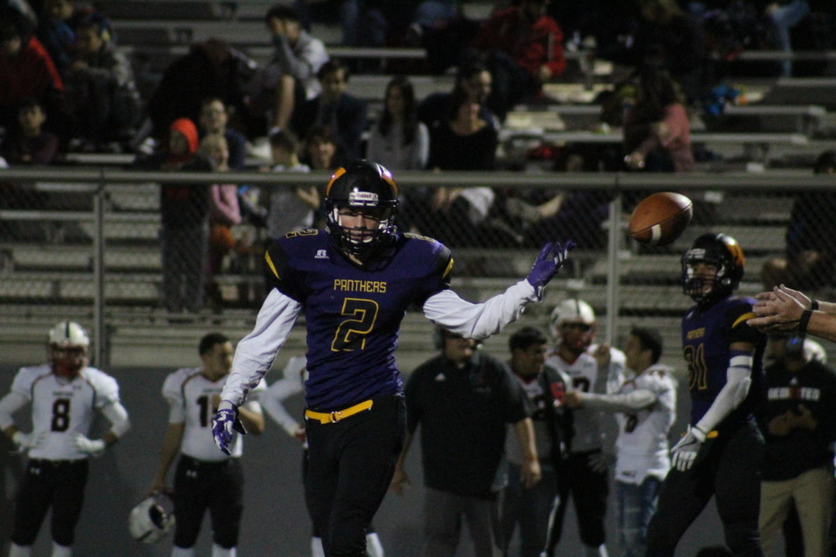 #2 Dillon Rublaitus tosses the football to the referee after a play. 