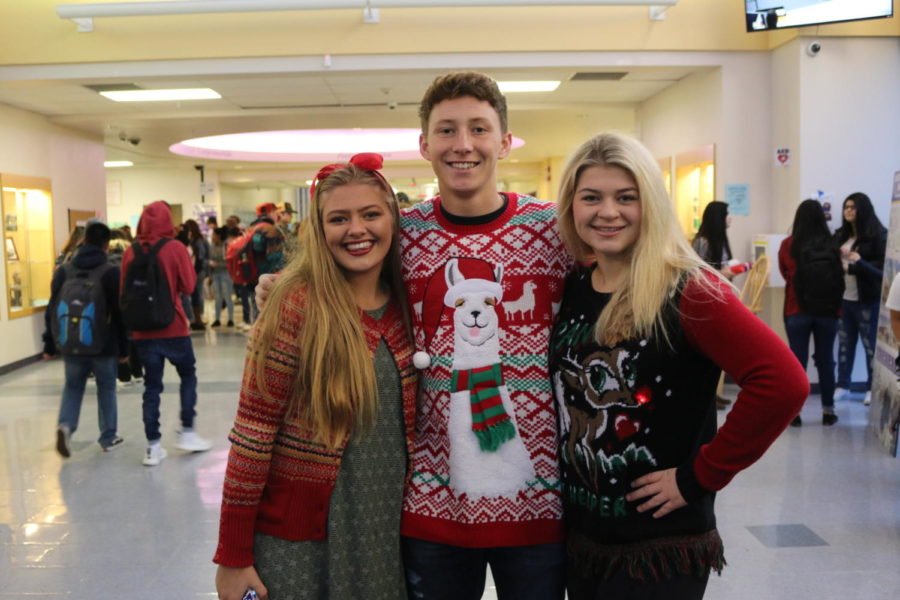 Freshman Ava Rosvold, senior Jake Slife, and junior Karissa Long showcase their WHS spirit with their ugly sweaters.