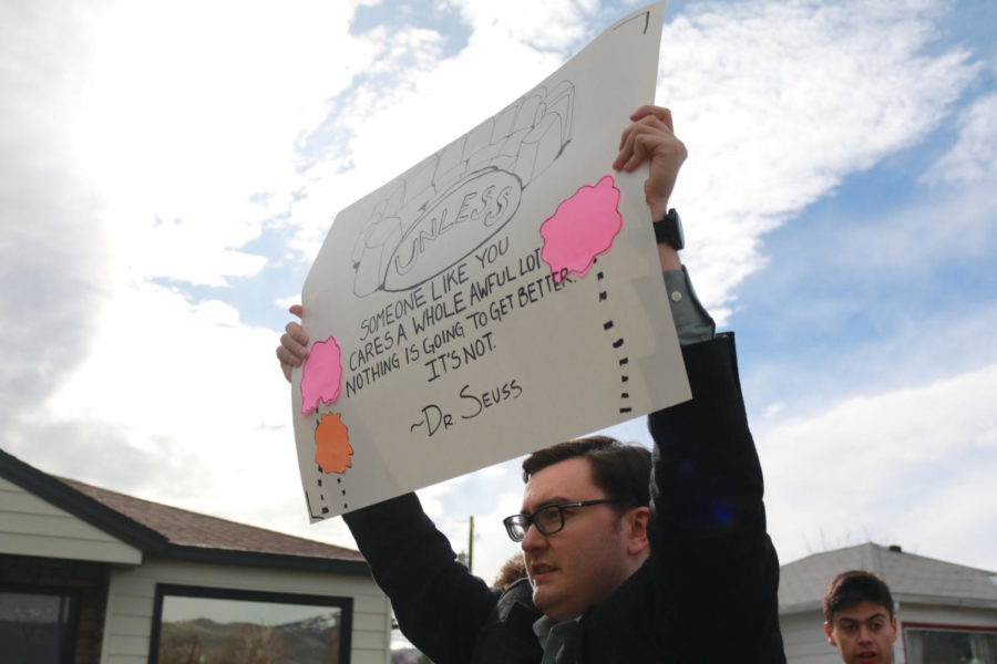 Chris Danko marches with his sign supporting activism. 