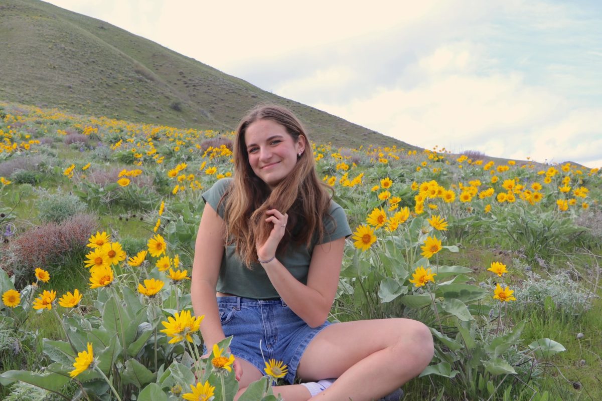 Maren poses for a picture in the wildflower covered hills of Wenatchee